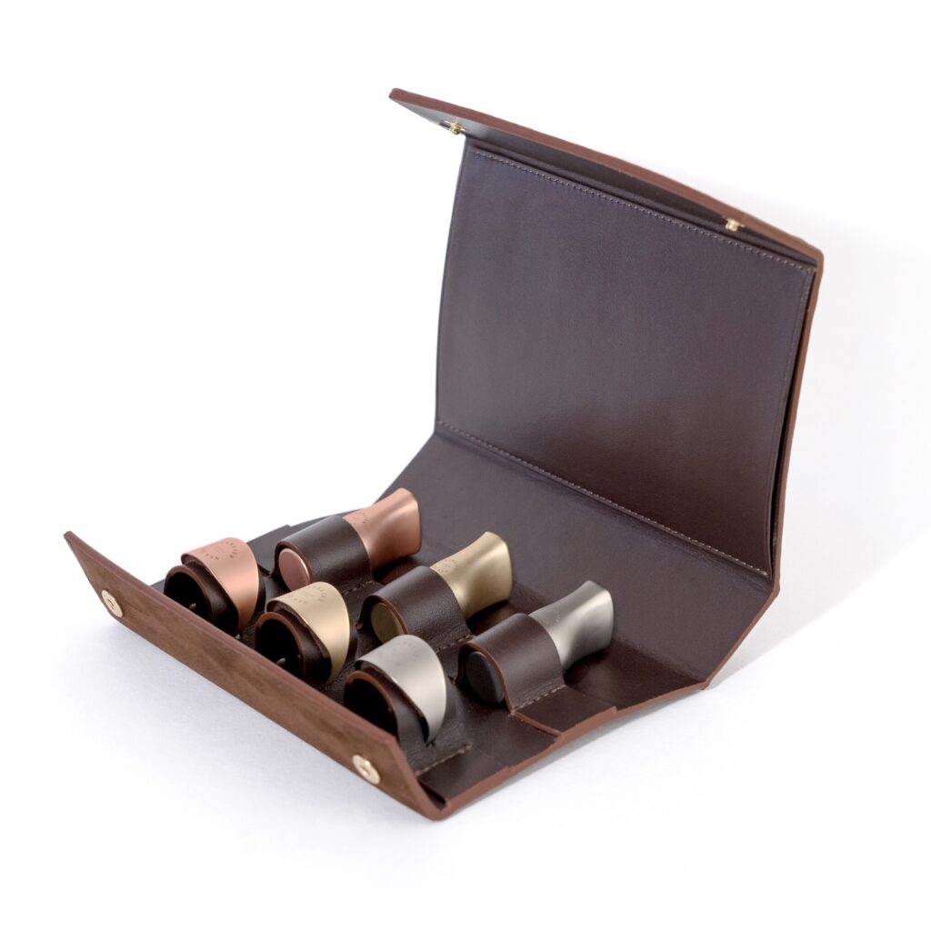 Stopper and rings for wine bottles in leather case