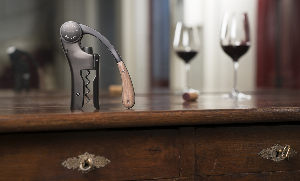 Oeno Motion Wood & Black lever corkscrew with cork on table