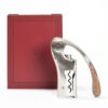 Lever corkscrew next to its red wooden case