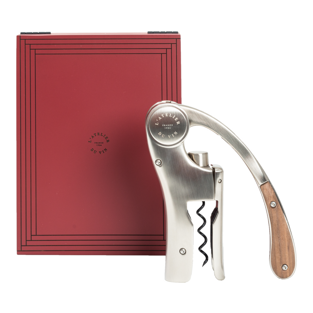 Lever corkscrew next to its red wooden case